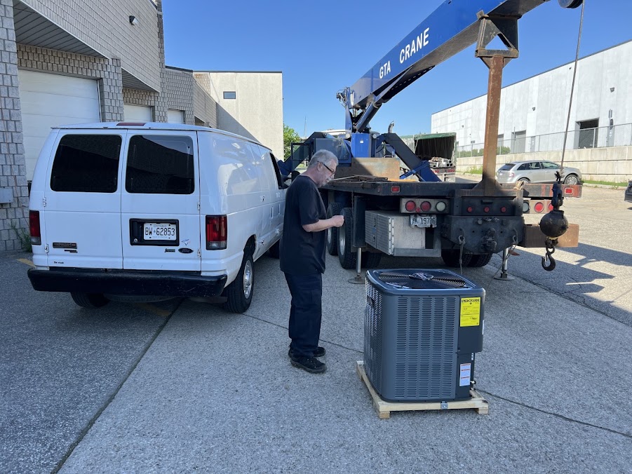 HVAC technician receiving a new outdoor air conditioning unit